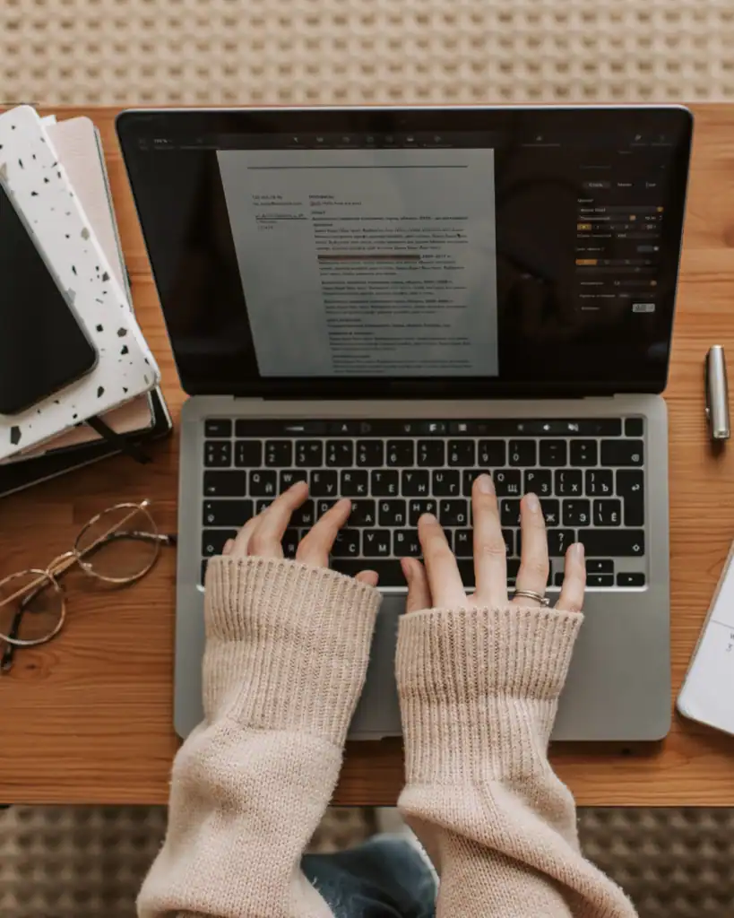 A woman reviewing a document like a professional beta reader reviews a manuscript, with a sharp eyes and detailed notes.